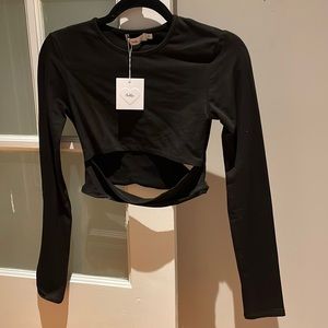 Adika black long sleeve top. Slightly cropped. Front slit detail. NWT.